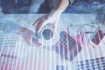 Double exposure of man and woman working together and financial chart hologram drawing. market analysis concept. Computer background. Top View.