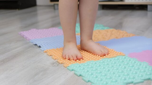 Toddler baby foot massage puzzle mat. Exercises for legs orthopedic massage carpet. prevention a child walks on a massage rubber carpet