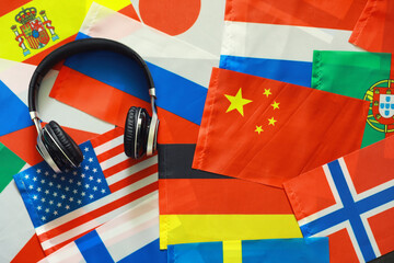 Learning foreign languages. Audio language courses. Background from countries flags and headphones...