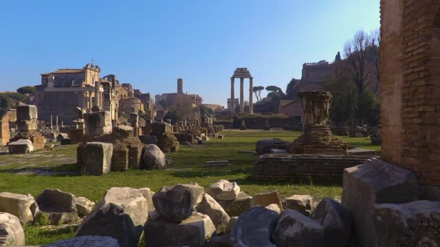 Steadicam shooting the main attraction of Rome, the ruins of the Roman Forum: The Basilica Julia, The Temple of Castor and Pollux, The Temple of Antoninus and Faustina, columns along the Via Sacra