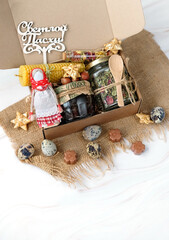 Happy Easter russian text. Easter gift box with jam jar, herbal tea, sweets, candle, traditional decor.  hand made zero waste gift for easter holiday. festive spring season. 