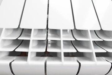 Heating radiator with close-up sections. The heating device is white.