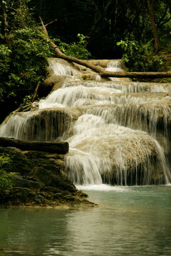 natural pool with a waterfall Kanchanuburi Thailand. Tree across a waterfall. © Tom