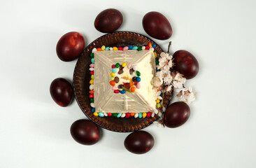 Easter composition. Eggs, apricot flowers and Orthodox Easter curd dessert in the form of a pyramid close-up on a white background. Happy Easter Holidays. Top view.