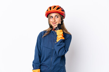Young hispanic cyclist woman isolated on white background thinking an idea while looking up