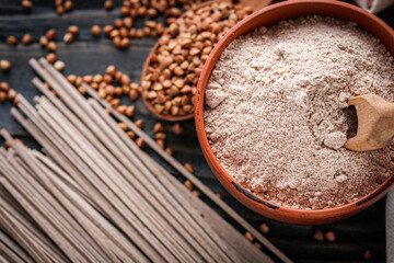 fresh natural buckwheat flour on a dark wooden rustic background culinary concept