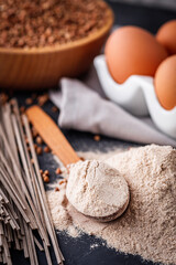 fresh natural buckwheat flour on a dark stone background culinary concept