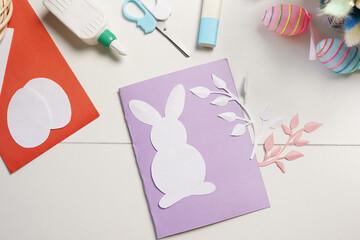 Diy Easter cards from paper. Volume greeting card with a bunny, on white background. Gift idea, decor Spring, Easter.