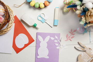 Diy Easter cards from paper. Volume greeting card with a bunny, on white background. Gift idea, decor Spring, Easter.