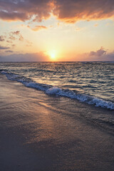 beautiful golden sunset on the beach over the sea with some dreamy clouds