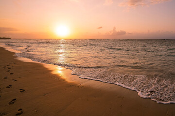 beautiful golden sunset on the beach over the sea with some dreamy clouds