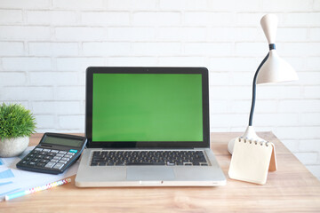 laptop with blank screen on office desk.