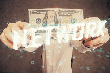 Double exposure of technology drawing hologram and us dollars bills and man hands. Data concept