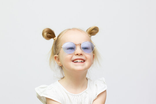 Little cool smilly girl in sunglasses isolated on white background