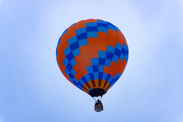 blue red hot air balloon flying into the sky