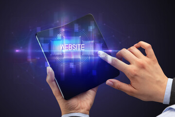 Businessman holding a foldable smartphone with WEBSITE inscription, new technology concept