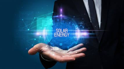 Man hand holding SOLAR ENERGY inscription, technology concept