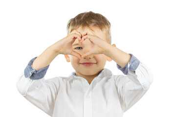 Handsome little boy making heart shape with fingers expressing love symbol