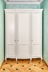 Three-section white wardrobe in classic style with carved legs in a modern hallway with green walls and elegant vintage wooden block parquet floor