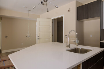 Kitchen contemporary with chrome fixture and white conter tops
