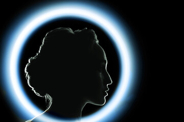 Young woman silhouette in blue neon circle ring in dark night life concept