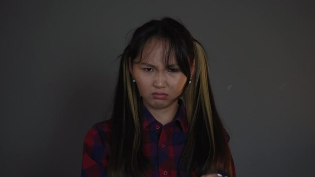 Portrait Of Asian Girl Looking At Camera, People Emotions, Woman Is Angry