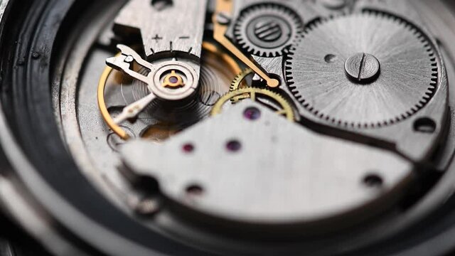 Close-up of the work of the mechanism and pendulum of an old mechanical wristwatch. The concept of the passage of time