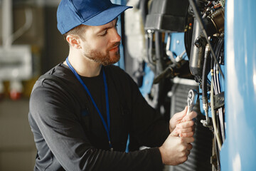 Man in uniform. Truck repair. Car malfunction