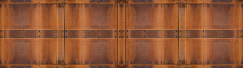 Grunge rusty corten steel facade wall with rivets, rust metal texture background banner panorama