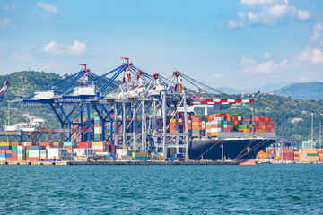 Container ship in the port awaiting unloading