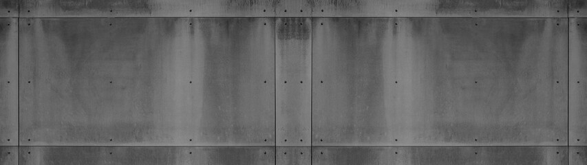 Black anthracite gray grey grunge dark wall with rivets, fiberglass concrete skin cement facade panels texture background banner panorama