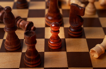 Pawn among other chess pieces, close up