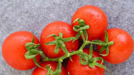 bright homemade tomatoes on a gray table