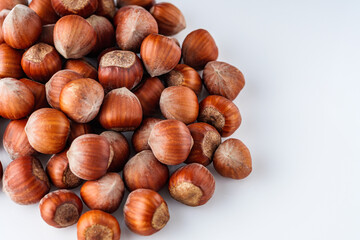 fresh natural hazelnuts on a white acrylic background