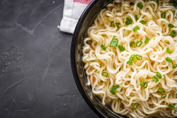 instant egg noodles on a dark stone background