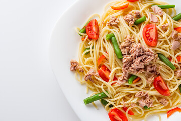 delicious traditional Italian pasta with tuna on a white background