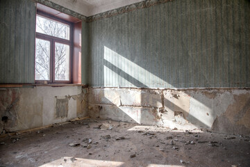 Beautiful room with light from the window in an abandoned house. Sunlight from the window. Old room. Abandoned interior.