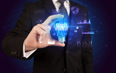 Businessman holding lightbulb with GROSS PROFIT inscription, Business idea concept