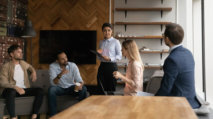 Diverse colleagues discussing project strategy, business partners sharing ideas at corporate...