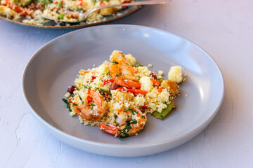 Couscous with vegetables and king prawns.