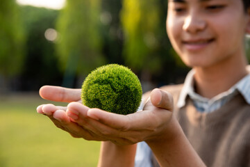 Asian teenager showing earth on hand, ecology and environment sustainable