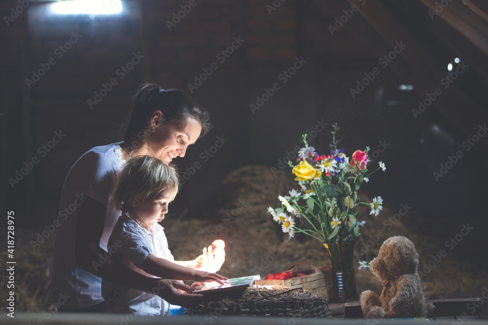 Sticker Beautiful mom and toddler blond boy, reading a book in the attic, nice atmosphere, flowers and strawberries