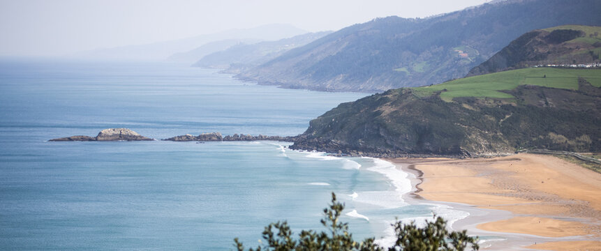 Aerial view of Monte Mollari and Zarautz beach on the coast of the Basque country in northern Spain. Landscape on a sunny day.