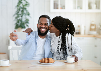 Selfie Time. Cheerful Black Guy Taking Photo With His Girlfriend In Kitchen