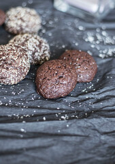 Chocolate chip cookies with coconut. Lie on a black and gray background.