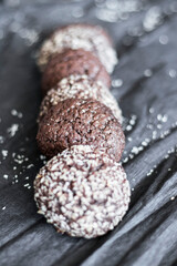 Chocolate chip cookies with coconut. Lie on a black and gray background.