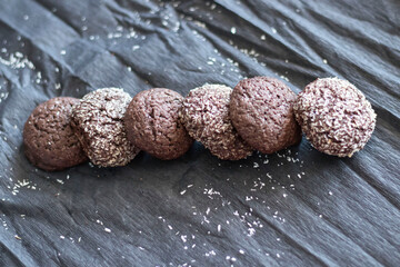 Chocolate chip cookies with coconut. Lie on a black and gray background.