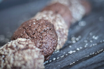 Chocolate chip cookies with coconut. Lie on a black and gray background.