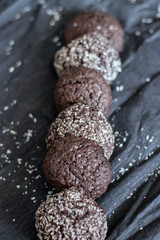 Chocolate chip cookies with coconut. Lie on a black and gray background.
