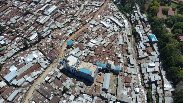 Aerial view over people playing on a rooftop in Kibera, largest slum in Africa